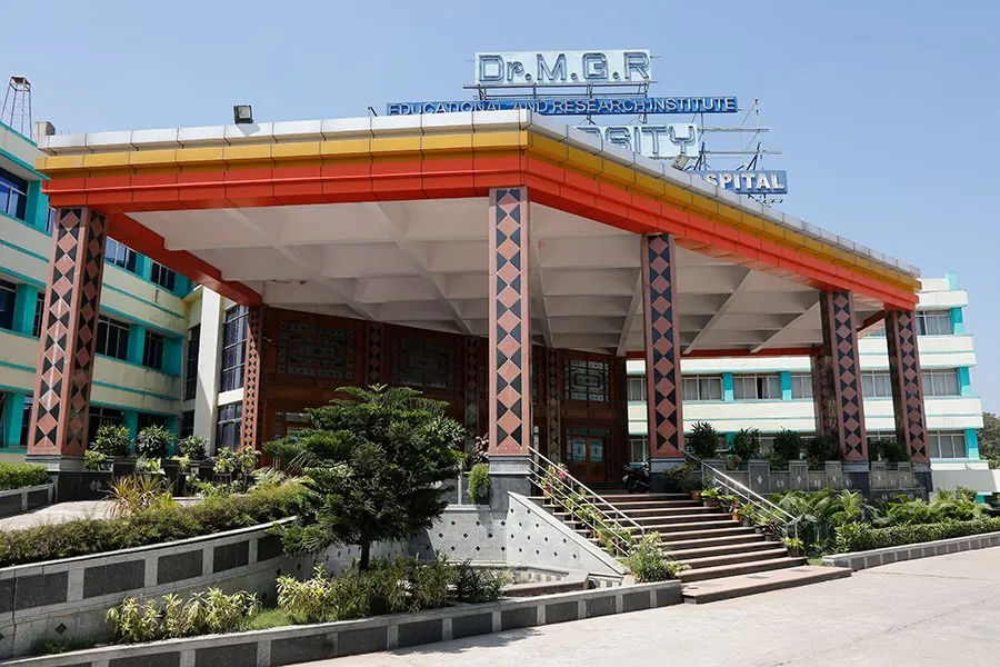 The entrance portico of the college and hospital building, with the Dr. M.G.R. Educational and Research Institute sign on the roof