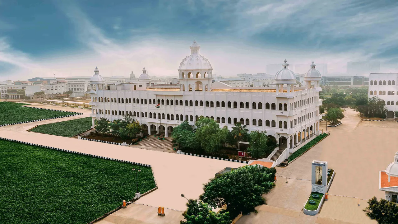 An aerial view of the white domed main building of Sathyabama and the lawns in front of it
