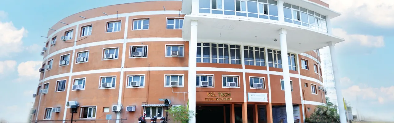 The curved brick-and-white front of the Vel Tech research park building, as a wide shallow banner (1920 by 600)