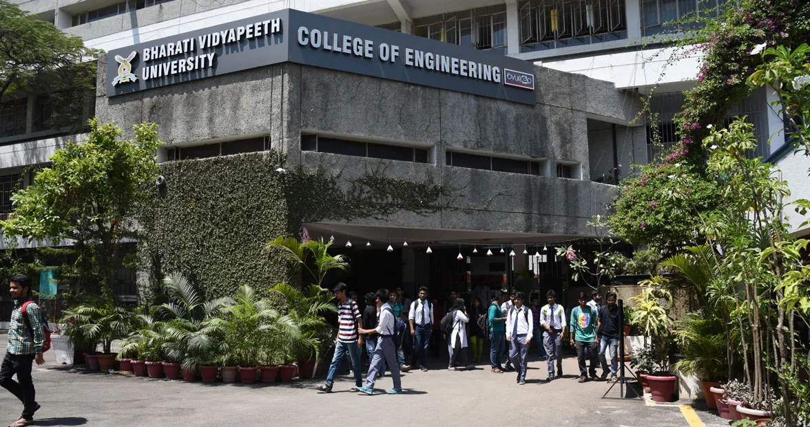 The entrance of Bharati Vidyapeeth College of Engineering, Pune, with the college signboard and students in the forecourt