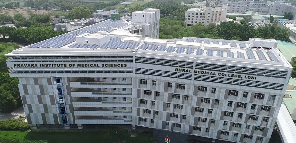 Aerial view of the Rural Medical College building, Loni, with 'Pravara Institute of Medical Sciences' and 'Rural Medical College, Loni' lettered on the facade. Note: a small 'WOWSlider' plugin mark sits in the bottom-right corner and should be cropped off